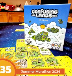 Board game "Confusing Lands" by Zak Eldsvoog displayed on a table with gameplay elements visible, featuring colorful cards and a vibrant design, promoting the Summer Marathon 2024 event.