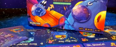 Deluxe edition of Cosmic Chains board game displayed with colorful game cards, featuring playful illustrations of satellites and space themes, set against a galaxy background, promoting competitive gameplay for 2 players aged 14 and up, with a playtime of 30-40 minutes. Summer Marathon 2024 event highlighted in the corner.