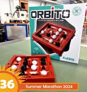 Image of the game "Orbito" by Flexiq, featuring a red game board with black and white game pieces arranged on it. The box is displayed in the background, highlighting its 2-player fast strategy gameplay. The image is part of the Summer Marathon 2024 event.