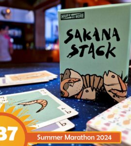 Sakana Stack card game box displayed on a table with playing cards featuring shrimp illustrations, set against a colorful background; Summer Marathon 2024 event highlighted in the corner.