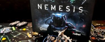 Image of the board game "Nemesis" featuring its box art and miniatures on a detailed game board. The scene highlights the game's sci-fi theme, showcasing player figures and components, set against a dark background. The text overlay indicates participation in the Summer Marathon 2024 event.