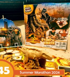 Jurassic World Stomp n Smash game featuring Kinetic Sand, a dinosaur figure, and colorful game board, highlighted for Summer Marathon 2024.