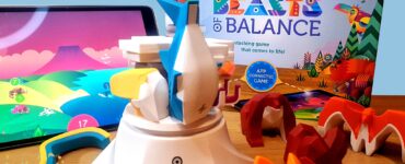 Colorful game pieces from "Beasts of Balance" are displayed alongside a tablet showing the game's app interface. The game box is visible in the background, highlighting its interactive stacking gameplay. The image promotes the Summer Marathon 2024 event.