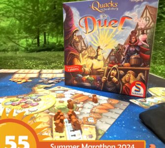Image of the board game "The Quacks of Quedlinburg: The Duel" by Wolfgang Warsch, featuring vibrant artwork on the box and a game setup for two players. The scene includes game pieces and a colorful game board, set against a natural green background, with a label indicating "55 Summer Marathon 2024."