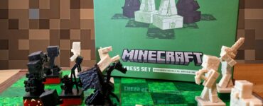Minecraft-themed chess set displayed on a green chessboard, featuring detailed character pieces from the game. The box in the background showcases the set's artwork, highlighting the clash between Overworld heroes and hostile mobs. Ideal for gaming enthusiasts and chess lovers. Summer Marathon 2024 promotional banner in the foreground.