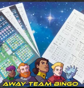 Colorful game sheets for "Away Team Bingo" displayed on a cosmic background, featuring character illustrations and various bingo patterns. Designed for 1-4 players, with a playtime of 15-30 minutes, suitable for ages 10 and up.