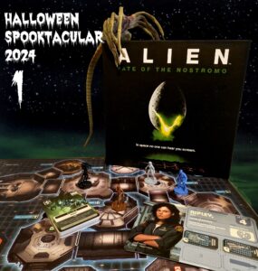 Alien Fate of the Nostromo board game setup with game pieces, character cards, and a detailed game board, featuring a backdrop of space. Halloween Spooktacular 2024 theme displayed prominently.