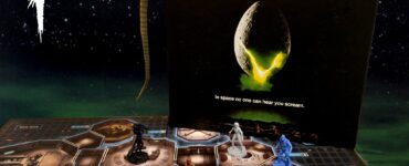 Alien Fate of the Nostromo board game setup with game pieces, character cards, and a detailed game board, featuring a backdrop of space. Halloween Spooktacular 2024 theme displayed prominently.