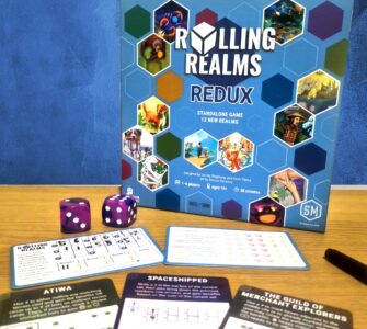 Board game "Rolling Realms: Redux" displayed with game components including dice and player sheets. The game is designed for 1-6 players, ages 14 and up, and features 12 new realms with a playtime of approximately 30 minutes.