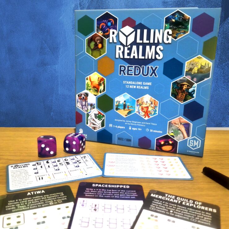 Board game "Rolling Realms: Redux" displayed with game components including dice and player sheets. The game is designed for 1-6 players, ages 14 and up, and features 12 new realms with a playtime of approximately 30 minutes.