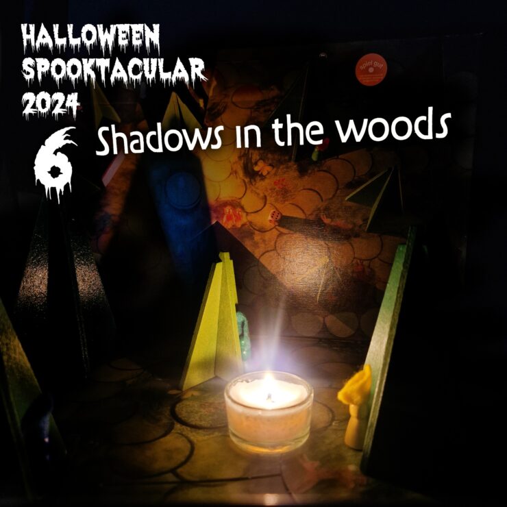 Halloween Spooktacular 2024 promotional image featuring the title "Shadows in the Woods." The scene includes colorful wooden figures and a lit candle, creating an eerie ambiance suitable for Halloween festivities.