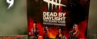 Dead by Daylight: The Board Game - Malicious Expansion displayed for Halloween Spooktacular 2024, featuring game box art and miniatures on the game board with action elements, dice, and character tokens.