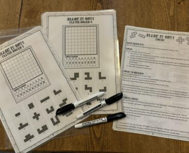 Printable game sheets for "Black It Out!" featuring player boards and game rules. The image showcases two player boards with grids and shapes, along with a rules sheet explaining gameplay and objectives. Markers are placed beside the sheets, ready for use.