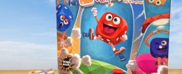 Colorful board game "Jumping Dice" featuring cartoon dice characters, game components including dice, cards, and a bell, set against a blue sky background.