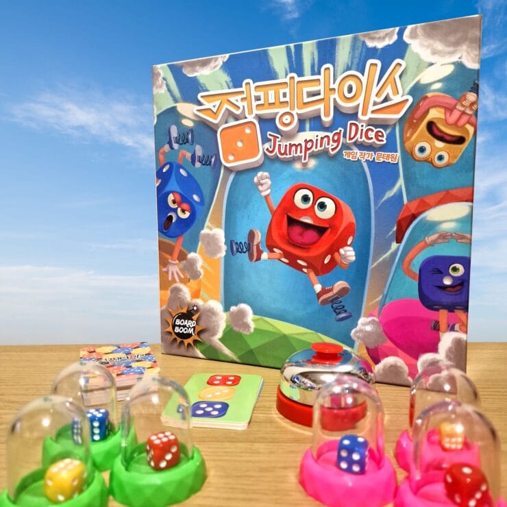 Colorful board game "Jumping Dice" featuring cartoon dice characters, game components including dice, cards, and a bell, set against a blue sky background.