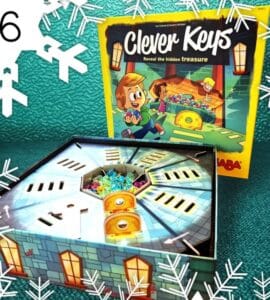 Colorful board game "Clever Keys" featuring a treasure hunt theme, with the game box and an open game board displaying hidden treasures and keys. Perfect for family game nights and enhancing problem-solving skills.