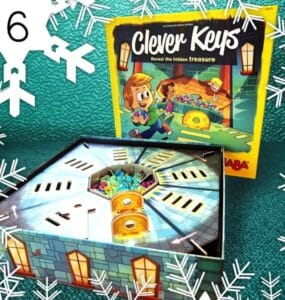 Colorful board game "Clever Keys" featuring a treasure hunt theme, with the game box and an open game board displaying hidden treasures and keys. Perfect for family game nights and enhancing problem-solving skills.