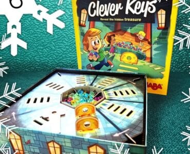 Colorful board game "Clever Keys" featuring a treasure hunt theme, with the game box and an open game board displaying hidden treasures and keys. Perfect for family game nights and enhancing problem-solving skills.