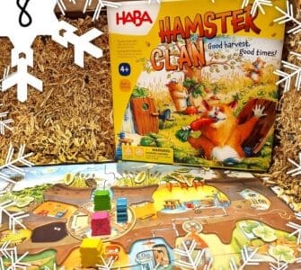 Colorful board game "Hamster Clan" by HABA displayed on a straw background, featuring game pieces and a vibrant game board, suitable for ages 4 and up.