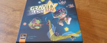 Colorful board game box for "Gravity Super Star" featuring playful characters and vibrant artwork, designed by Julian Allain and Gyom. The box showcases a dynamic theme with elements of gravity and adventure, ideal for family game nights.