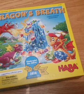 Colorful board game box of "Dragon's Breath" by HABA, featuring playful dragons and a sparkling gem theme, awarded the 2018 Children's Game of the Year.