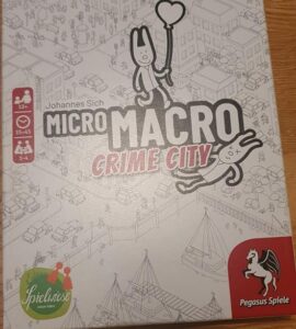 Board game box for "MicroMacro: Crime City" by Johannes Sich, featuring playful illustrations and highlighting gameplay for 1-4 players aged 12 and up, with a playtime of 15-45 minutes.