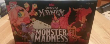 Box cover of the D&D Dungeon Mayhem: Monster Madness card game, featuring colorful cartoon-style characters like a dragon, an owl, and a whimsical creature. The game is designed for 2 to 6 players aged 8 and up, emphasizing fun and action-packed gameplay.