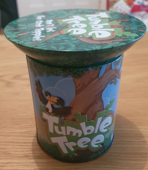 Tumble Tree game box featuring vibrant illustrations of a tree and a bird, designed for family-friendly fun and skill-building activities.