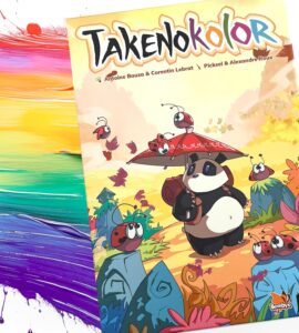 Cover of the board game "Takenoko Color," featuring a cartoon panda holding an umbrella surrounded by colorful ladybugs and vibrant landscapes. The artwork highlights a playful theme and colorful illustration, perfect for family game nights.