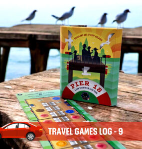 Travel game log showcasing the "Pier 18" card game box on a wooden pier with seabirds in the background, highlighting outdoor gaming experiences ideal for road trips and family fun.