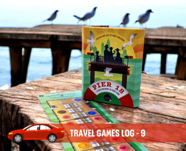 Travel game log showcasing the "Pier 18" card game box on a wooden pier with seabirds in the background, highlighting outdoor gaming experiences ideal for road trips and family fun.