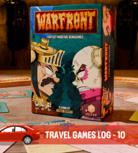 Box of the board game "Warfront: Fantasy Warfare Reimagined" by Hector Clegg, displayed on a tabletop surrounded by game cards and components. The stylish artwork features vibrant colors and characters, highlighting the game's unique theme. Ideal for travel gaming enthusiasts.