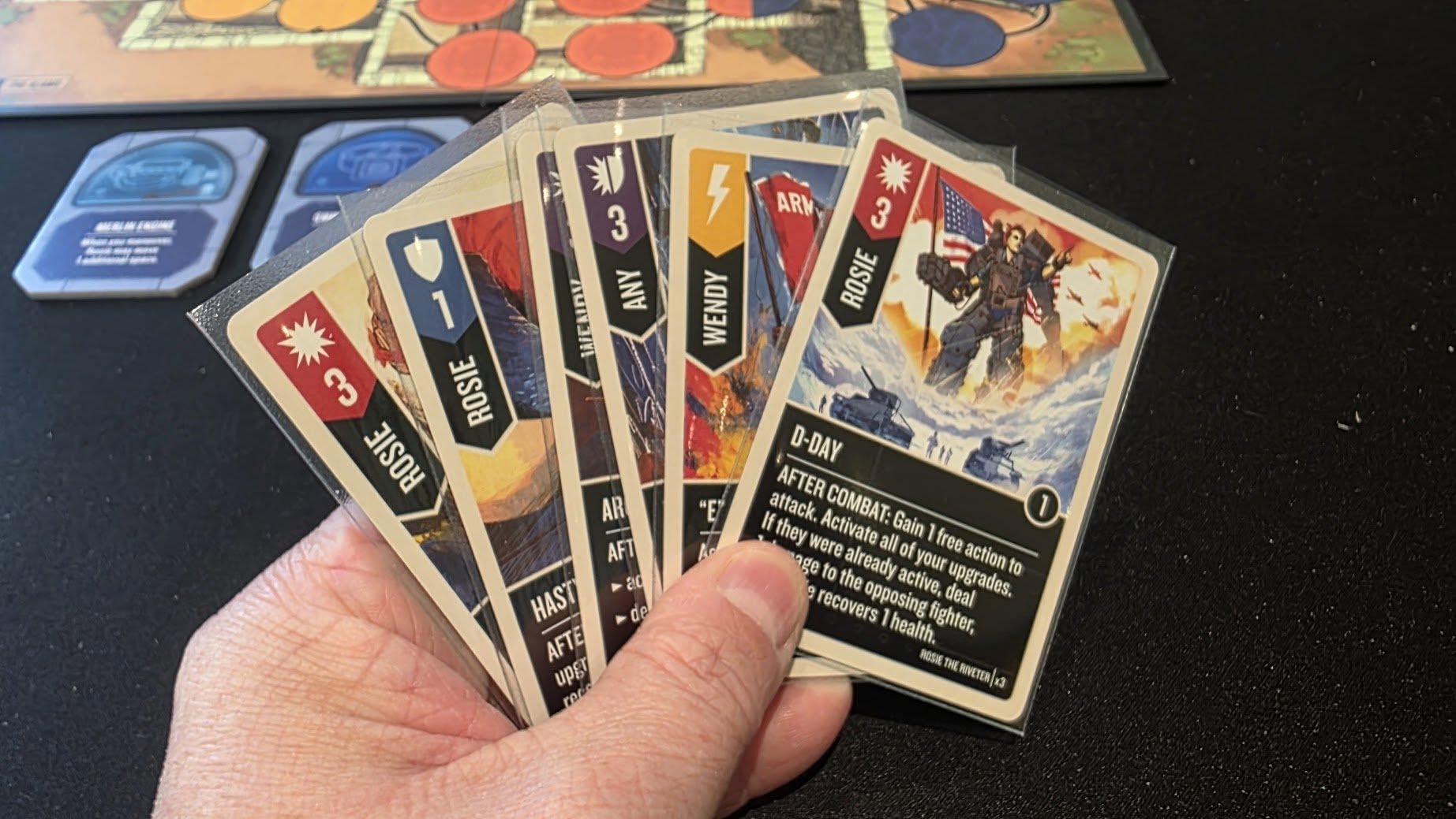 May be an image of text that says "全期事一た場 ARM オ ና ¥ حى WENDY ANY ROSIE 3 WENDY ROSIE E AR AFT de del D-DAY AFTER attack. attack, COMBAT: Gain free action lfthey Activate ge already allof your active, deal deal upgrades. to 0 recovers pposing health. ighter, RESAN NITAY ROETERNS HAST AFTE upg หมม"